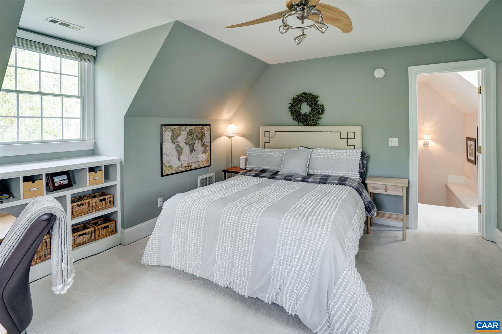 3315 Darby Road Keswick, VA 22947 - Photo 41 of 67 a bedroom with a bed and a chandelier