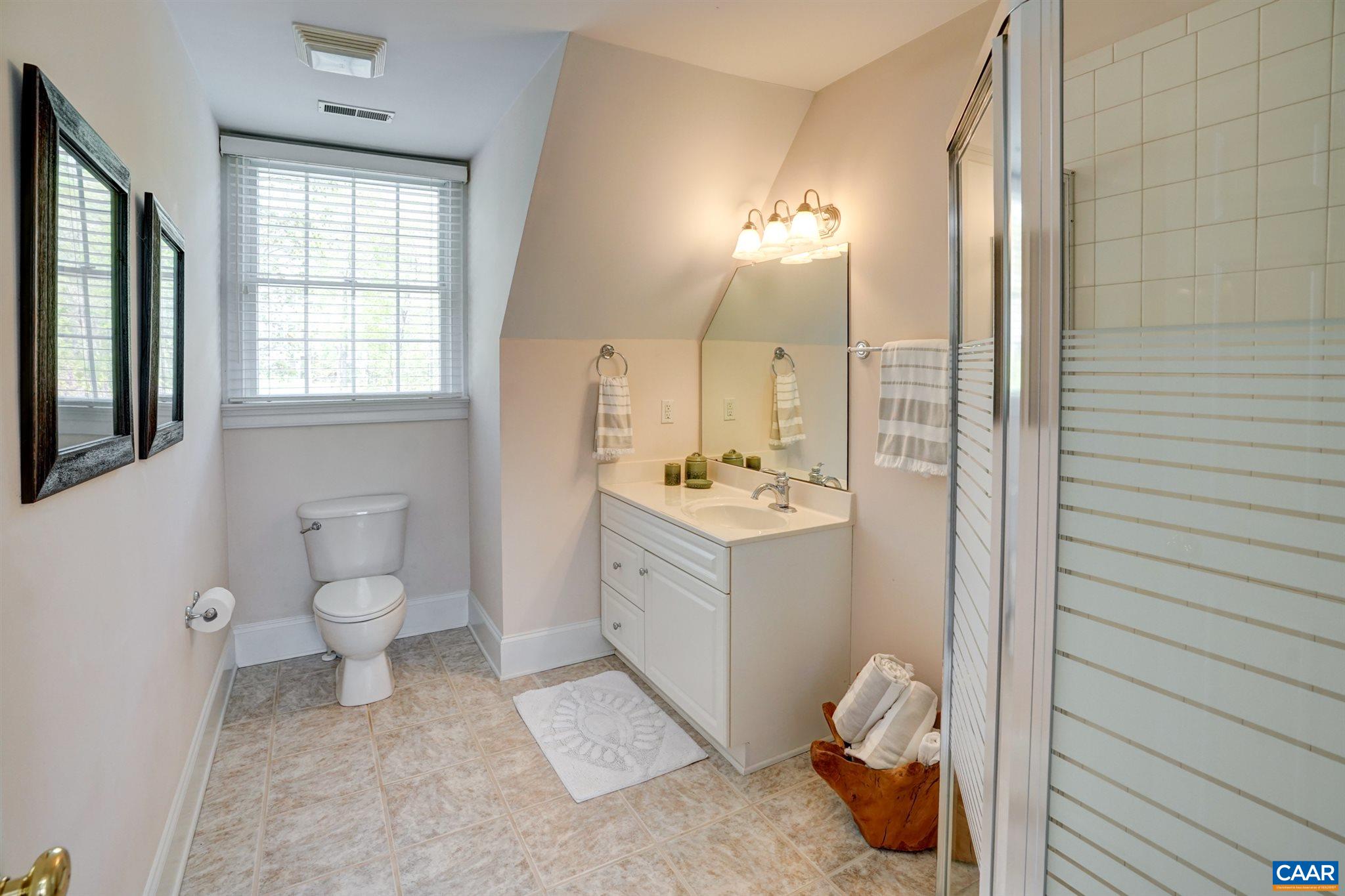 3315 Darby Road Keswick, VA 22947 - Photo 42 of 67 a bathroom with a toilet sink and mirror