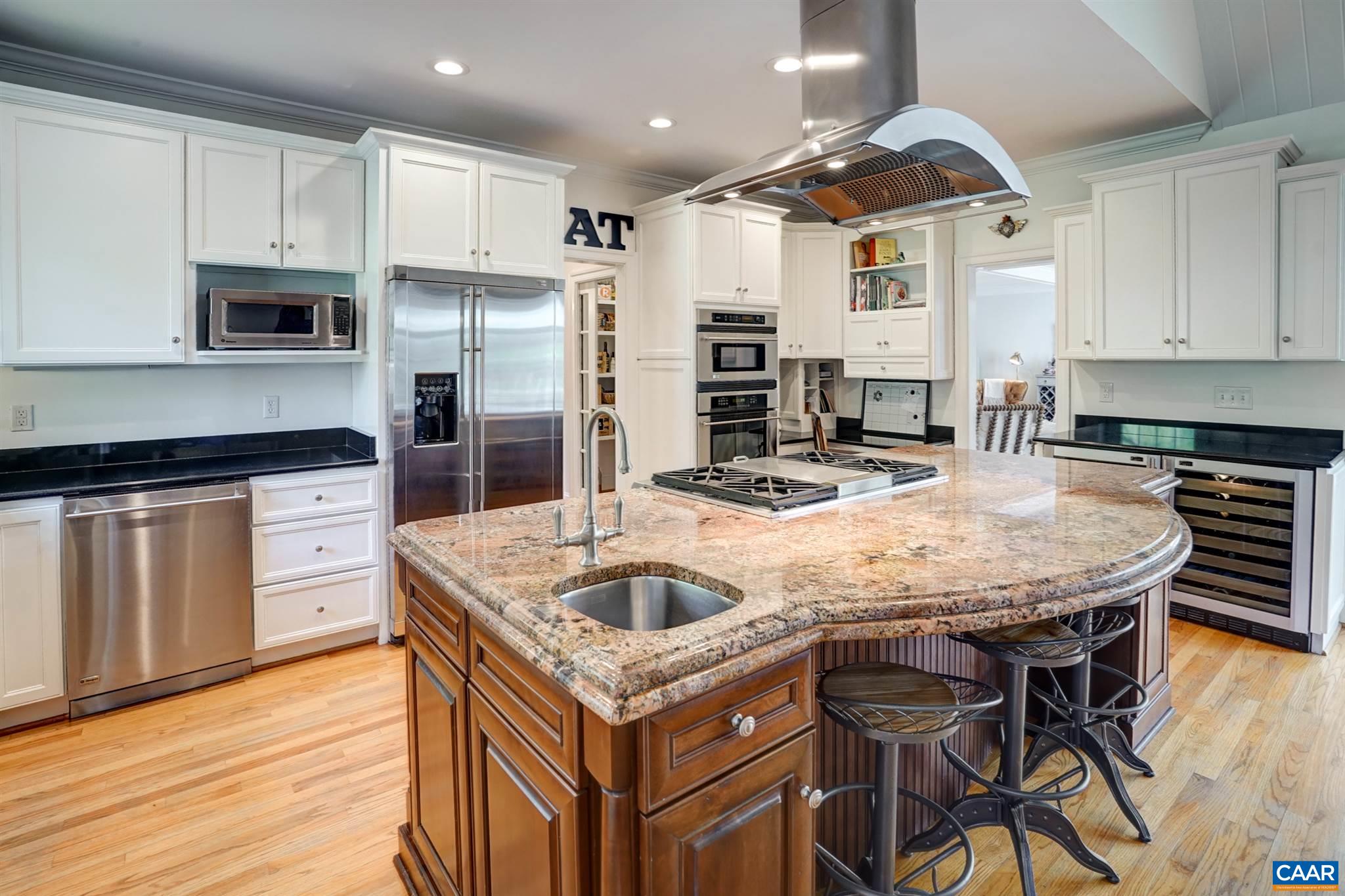 3315 Darby Road Keswick, VA 22947 - Photo 5 of 67 a kitchen with stainless steel appliances granite countertop a kitchen island a stove a table and chairs