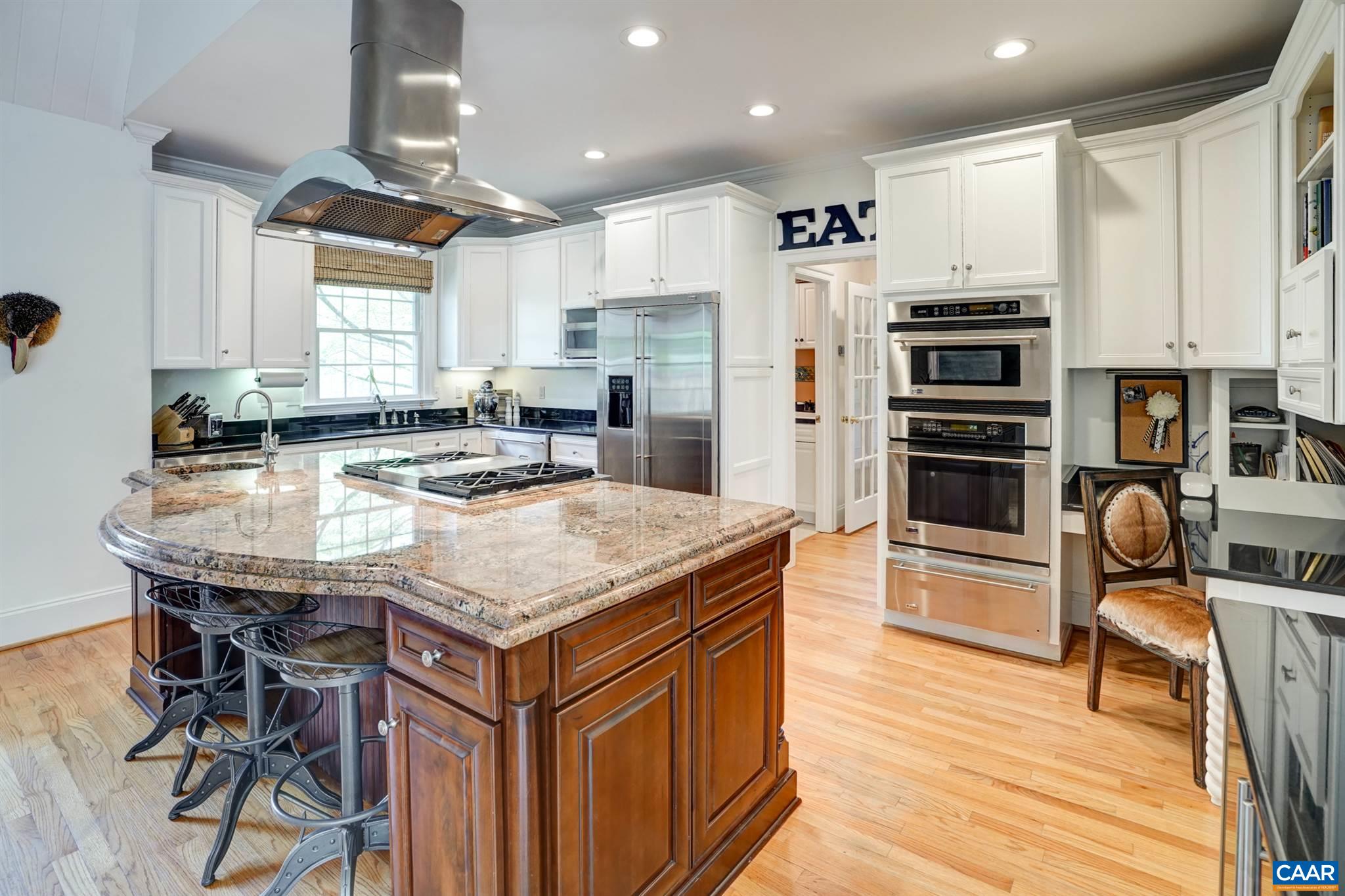 3315 Darby Road Keswick, VA 22947 - Photo 7 of 67 a kitchen with stainless steel appliances granite countertop a table chairs sink refrigerator and microwave