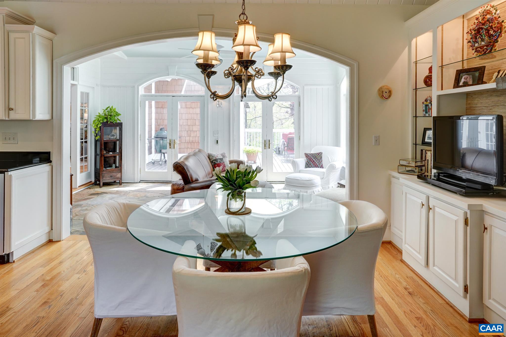 3315 Darby Road Keswick, VA 22947 - Photo 10 of 67 a dining room with wooden floor a chandelier a wooden table and chairs