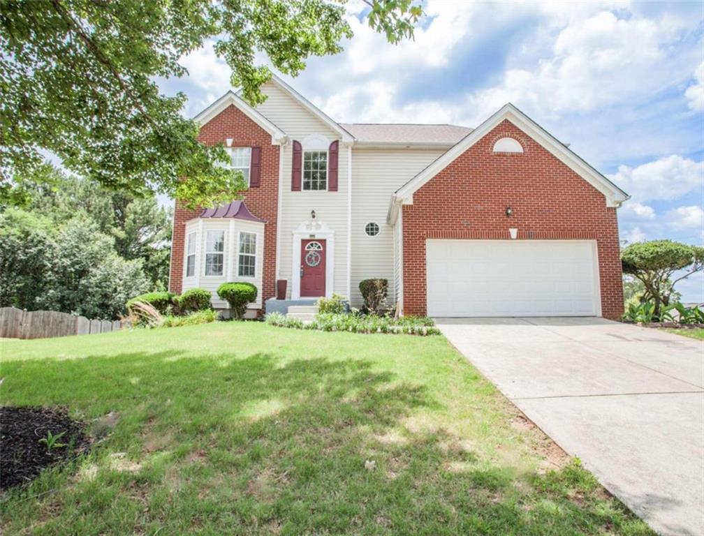 2064 Dartmoth Way Villa Rica, GA 30180 - Photo 1 of 1 a front view of a house with a yard and garage
