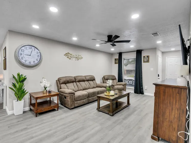 a living room with furniture and a clock