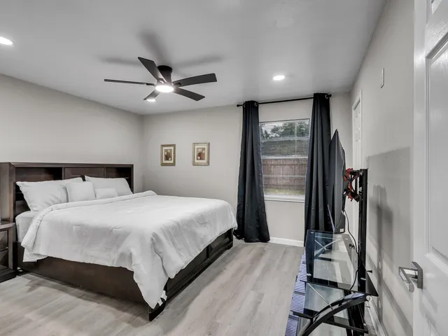 a bedroom with a bed and a ceiling fan