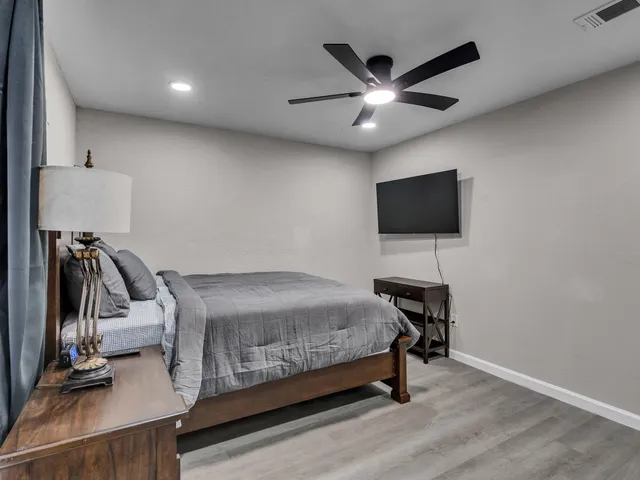 a bedroom with a bed and a flat screen tv