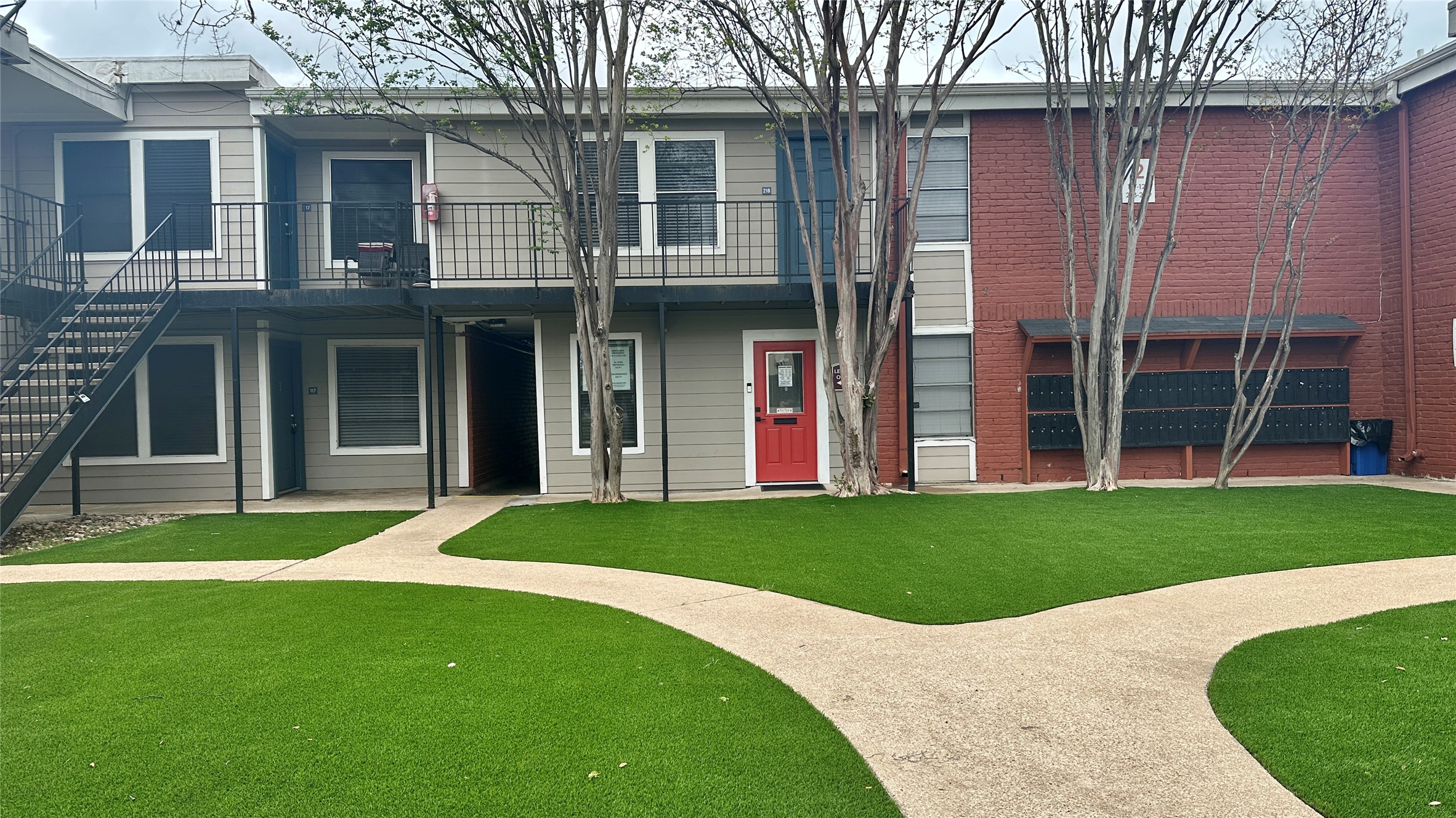 5426 Menchaca Road, Unit 125 Austin, TX 78745 - Photo 5 of 8 Manicured artificial turf lawn with concrete pathways