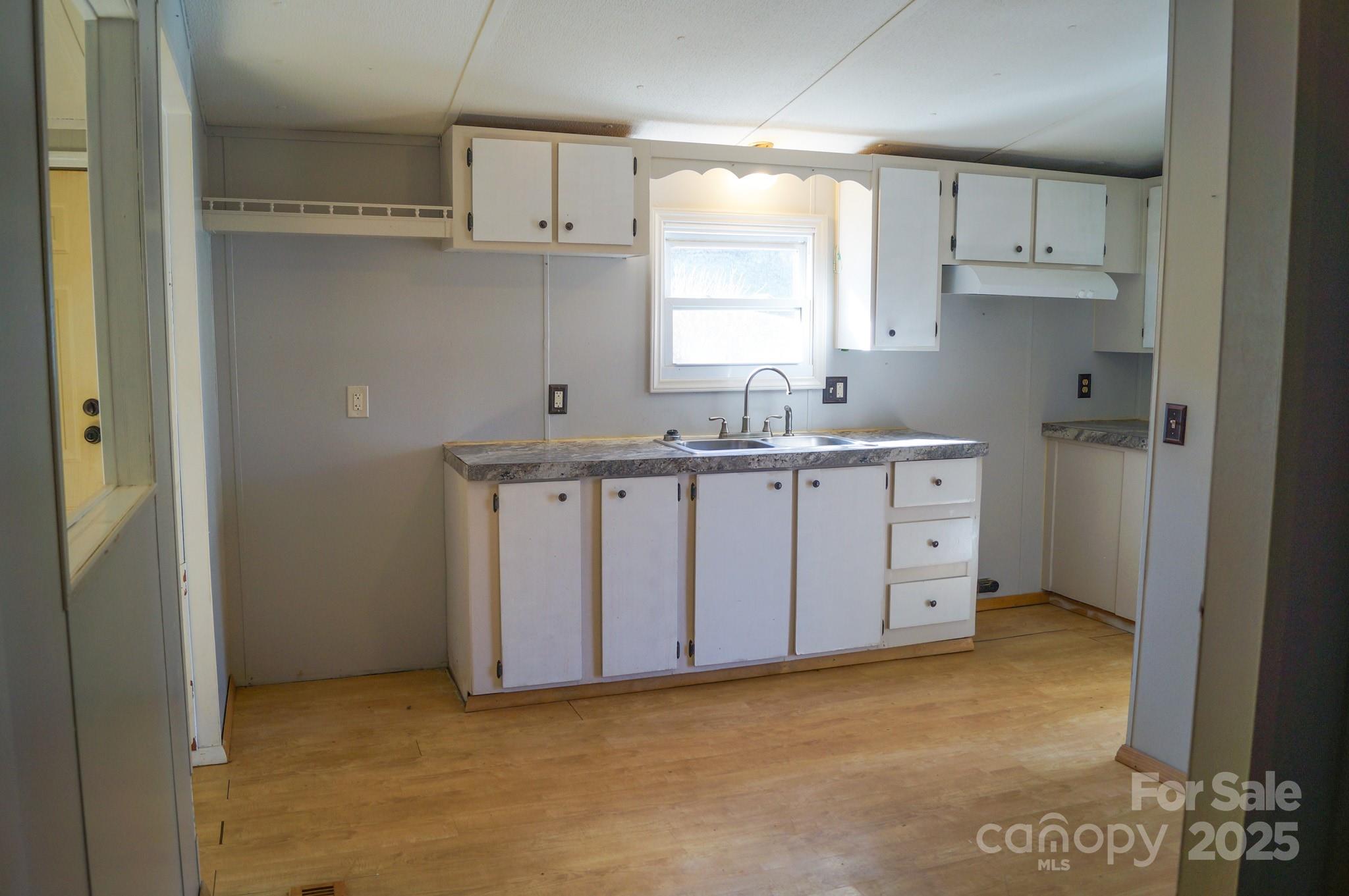 105 Lane Street Morganton, NC 28655 - Photo 8 of 19 a kitchen with stainless steel appliances granite countertop a sink stove and cabinets
