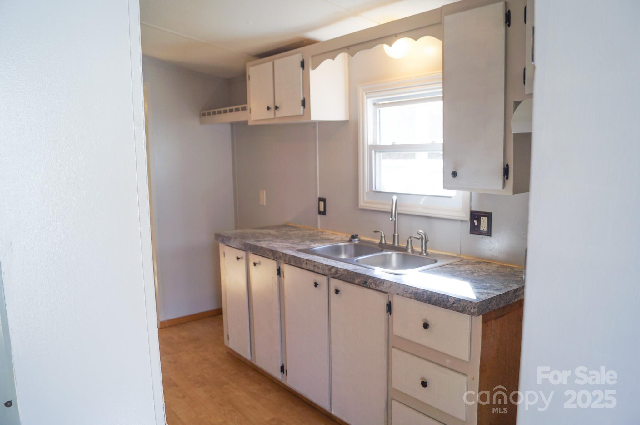 105 Lane Street Morganton, NC 28655 - Photo 10 of 19 a bathroom with a granite countertop sink and a window