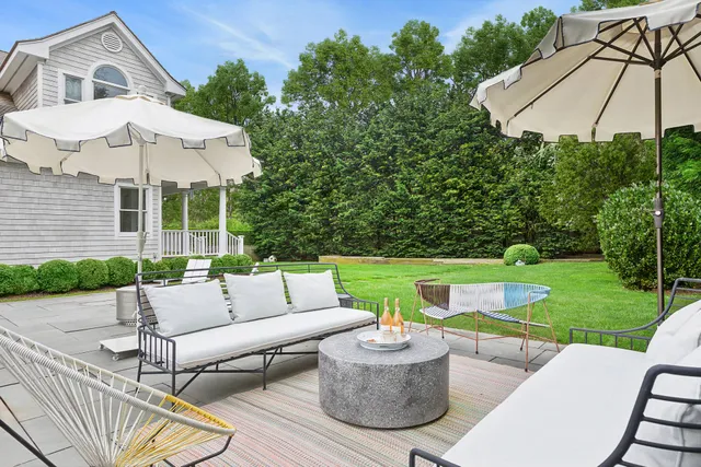 a living room with fireplace furniture and a rug