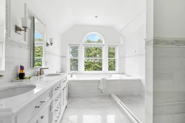 a bedroom with a bed and a large window with the outer view