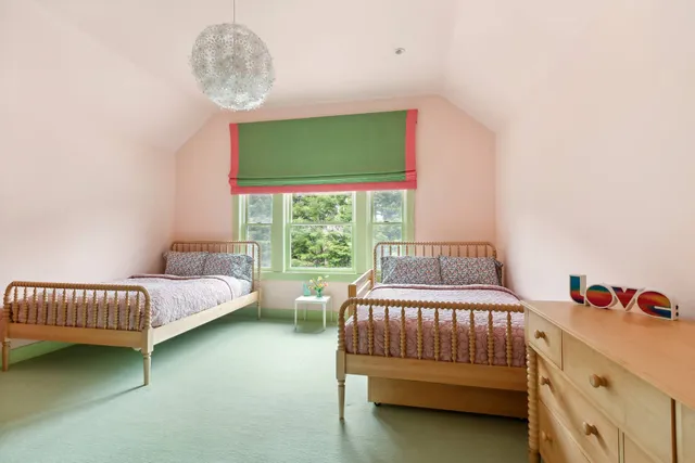 a bedroom with a large bed and a flat screen tv