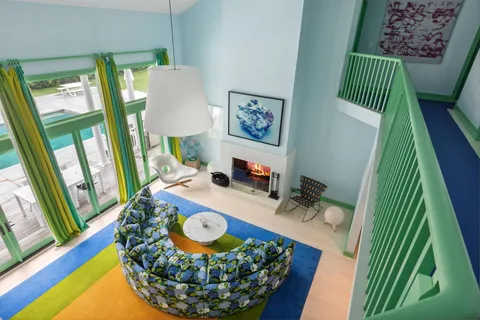 a living room with furniture a rug and a fireplace