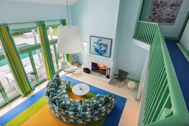 a living room with furniture a rug and a fireplace