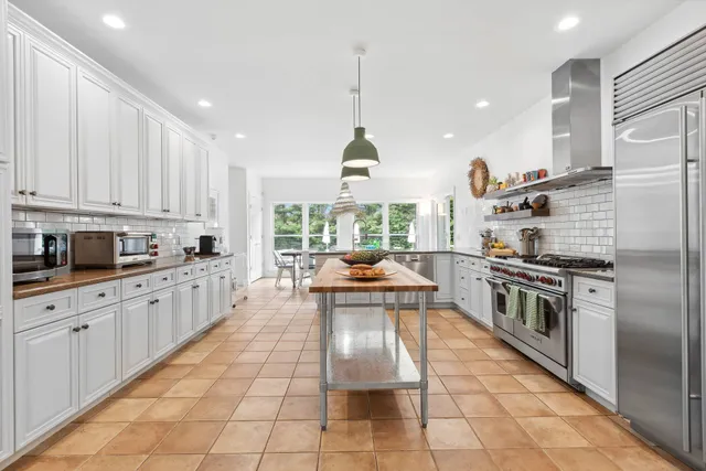 a view of a dining room with furniture large windows and wooden floor