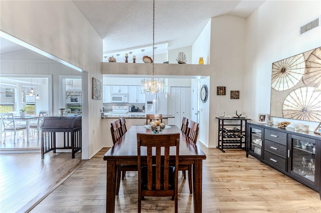 7443 Willowbrook Drive Spring Hill, FL 34606 - Photo 13 of 54 a view of a dining room with furniture and wooden floor