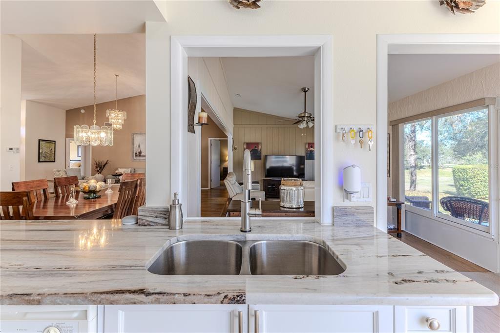 7443 Willowbrook Drive Spring Hill, FL 34606 - Photo 17 of 54 a kitchen with granite countertop a sink and a window