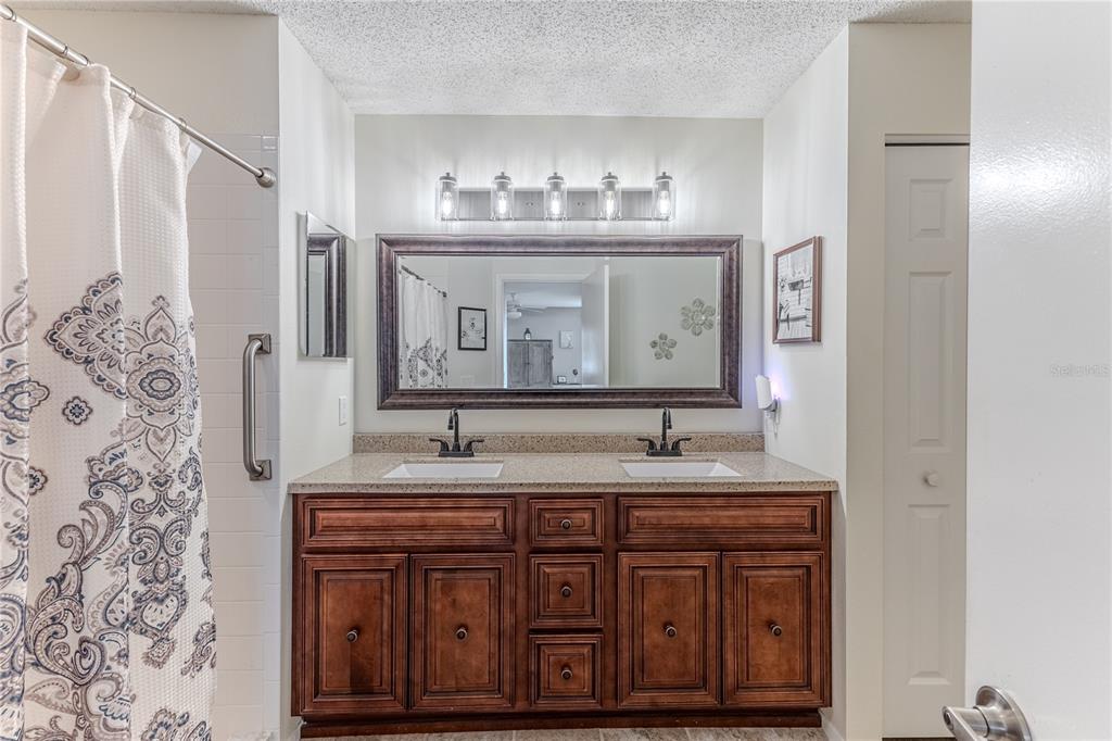 7443 Willowbrook Drive Spring Hill, FL 34606 - Photo 25 of 54 a bathroom with a granite countertop sink and a mirror