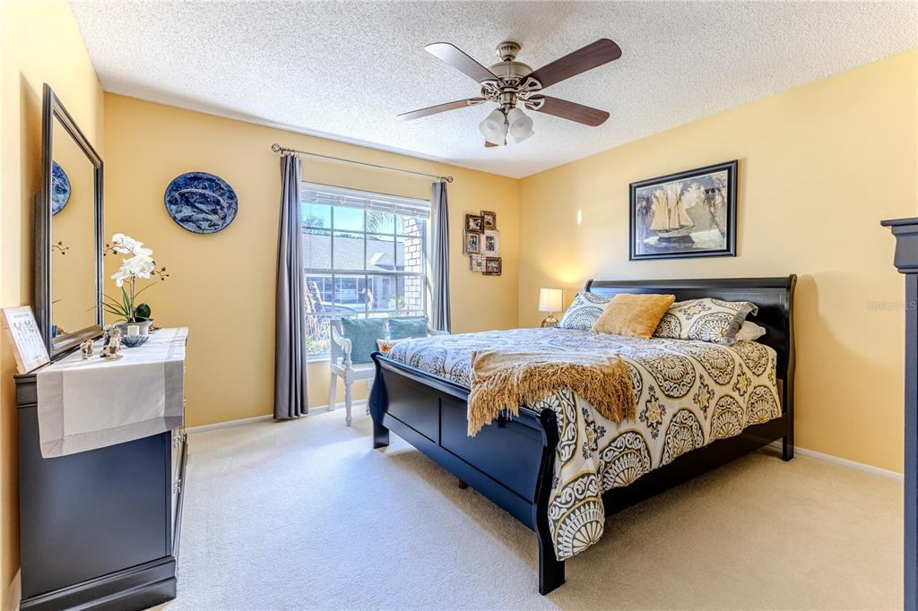 7443 Willowbrook Drive Spring Hill, FL 34606 - Photo 28 of 54 a spacious bedroom with a bed and a table