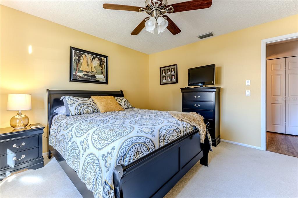 7443 Willowbrook Drive Spring Hill, FL 34606 - Photo 29 of 54 a bedroom with a bed and a tv
