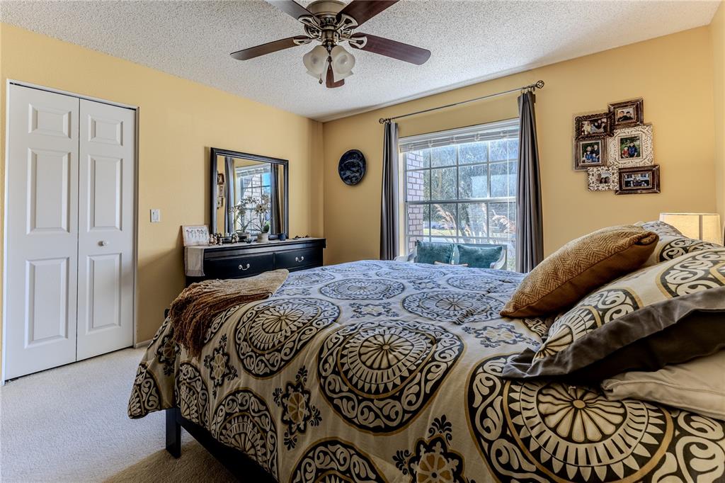 7443 Willowbrook Drive Spring Hill, FL 34606 - Photo 30 of 54 a bedroom with a large bed and a window