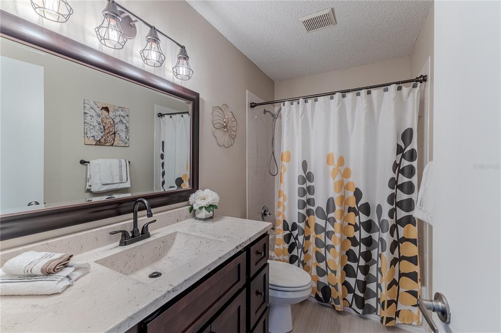 7443 Willowbrook Drive Spring Hill, FL 34606 - Photo 31 of 54 a bathroom with a sink and a mirror