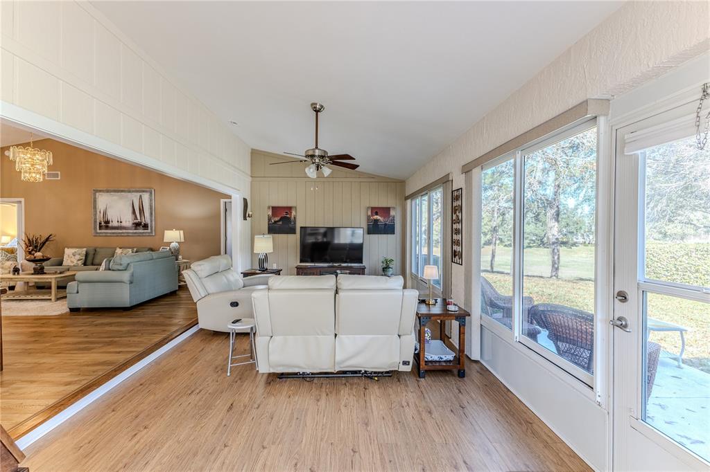 7443 Willowbrook Drive Spring Hill, FL 34606 - Photo 36 of 54 a living room with furniture and a flat screen tv