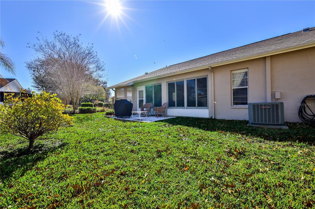7443 Willowbrook Drive Spring Hill, FL 34606 - Photo 39 of 54 a view of a house with backyard and porch