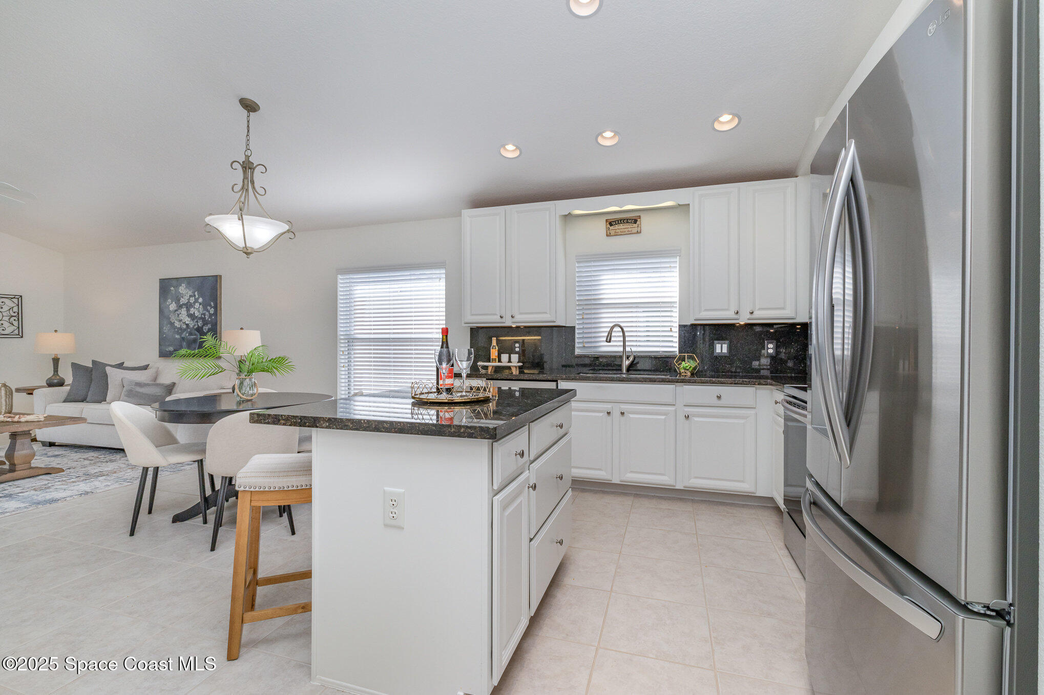 3053 Galindo Circle Melbourne, FL 32940 - Photo 14 of 83 a kitchen with a sink cabinets and refrigerator