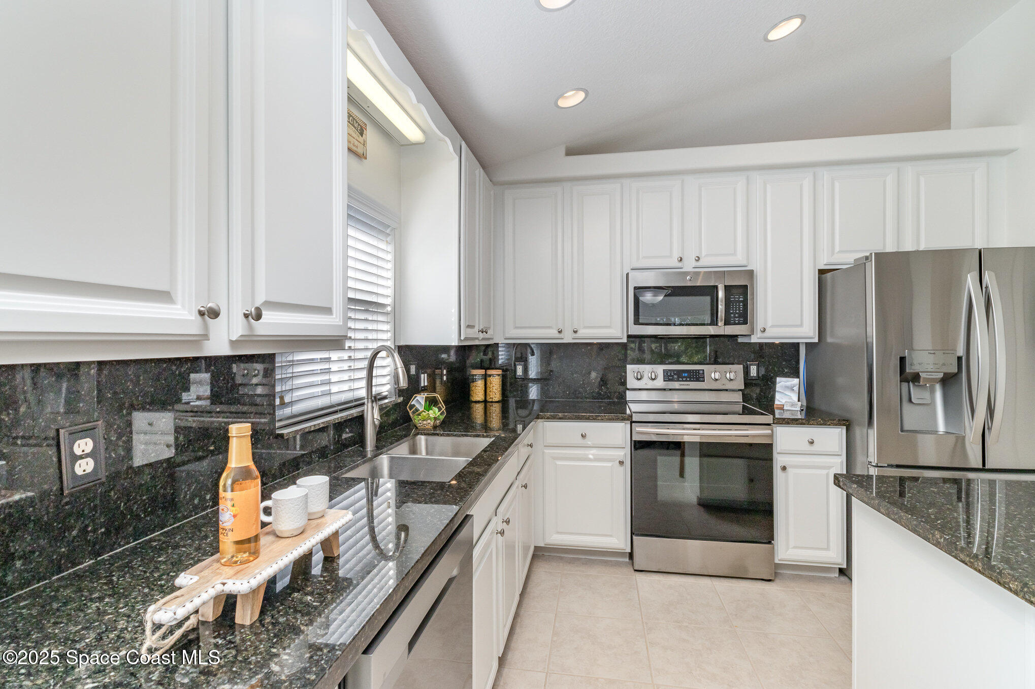 3053 Galindo Circle Melbourne, FL 32940 - Photo 17 of 83 a kitchen with stainless steel appliances a stove a sink and a refrigerator