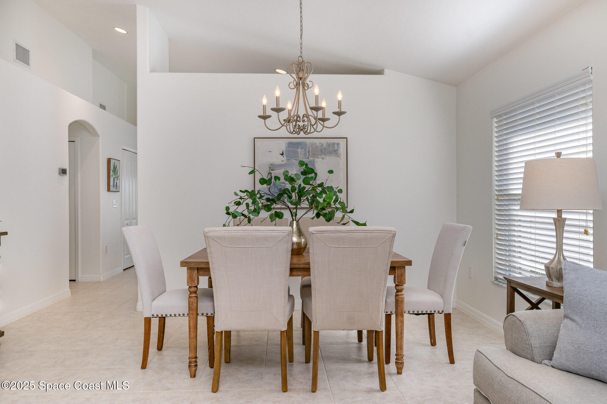 3053 Galindo Circle Melbourne, FL 32940 - Photo 19 of 83 a view of a dining room with furniture and chandelier