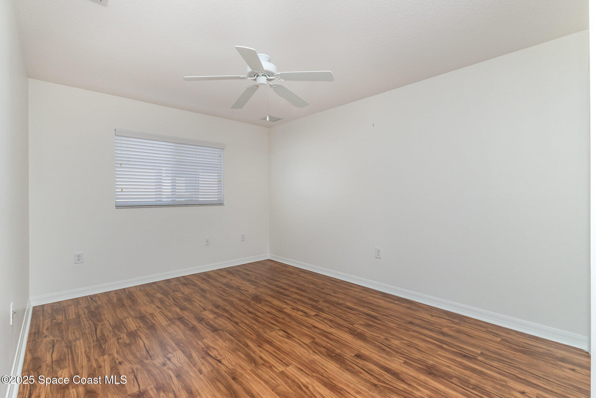 3053 Galindo Circle Melbourne, FL 32940 - Photo 26 of 83 an empty room with a window and ceiling fan