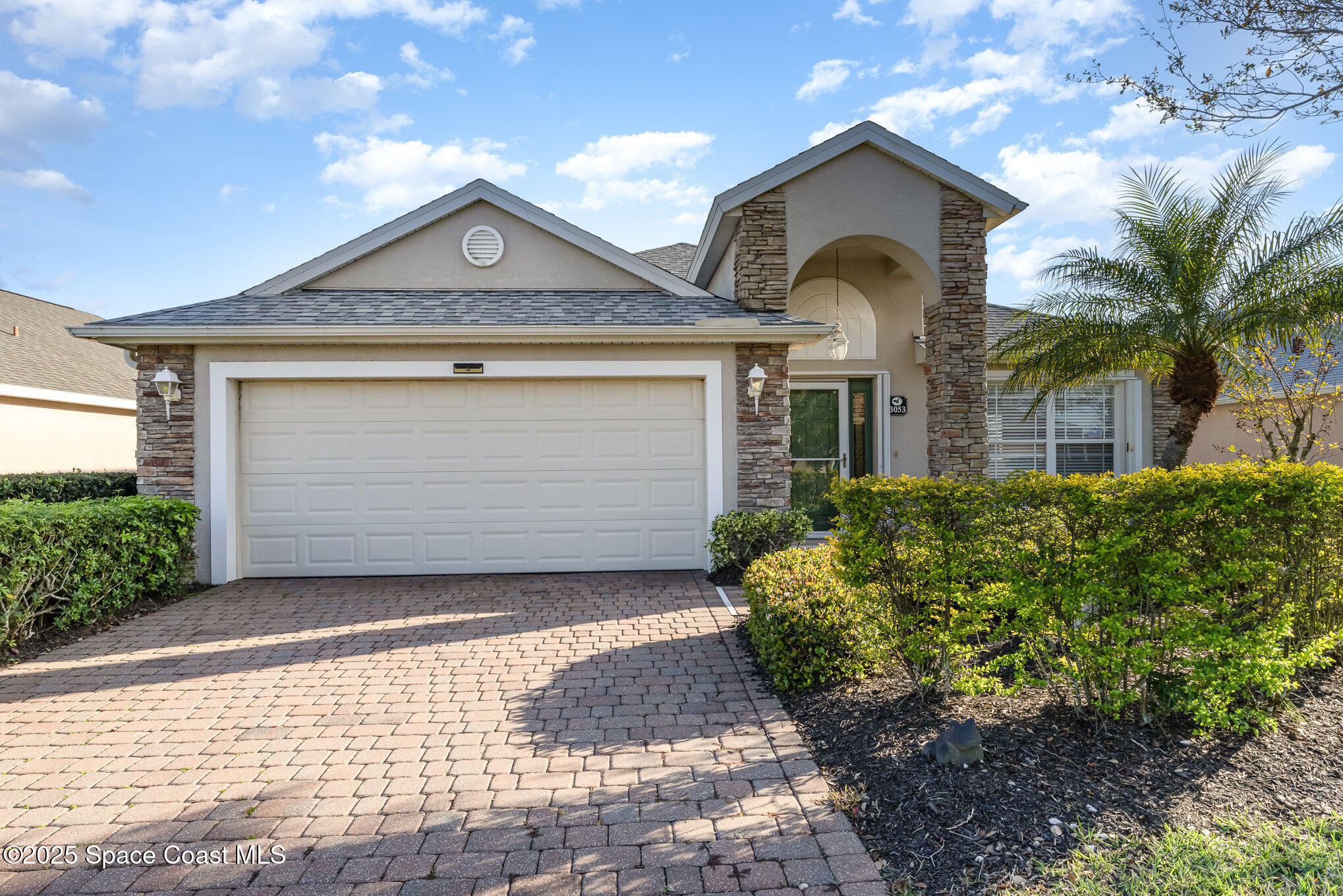 3053 Galindo Circle Melbourne, FL 32940 - Photo 3 of 83 a front view of a house with a yard and garage