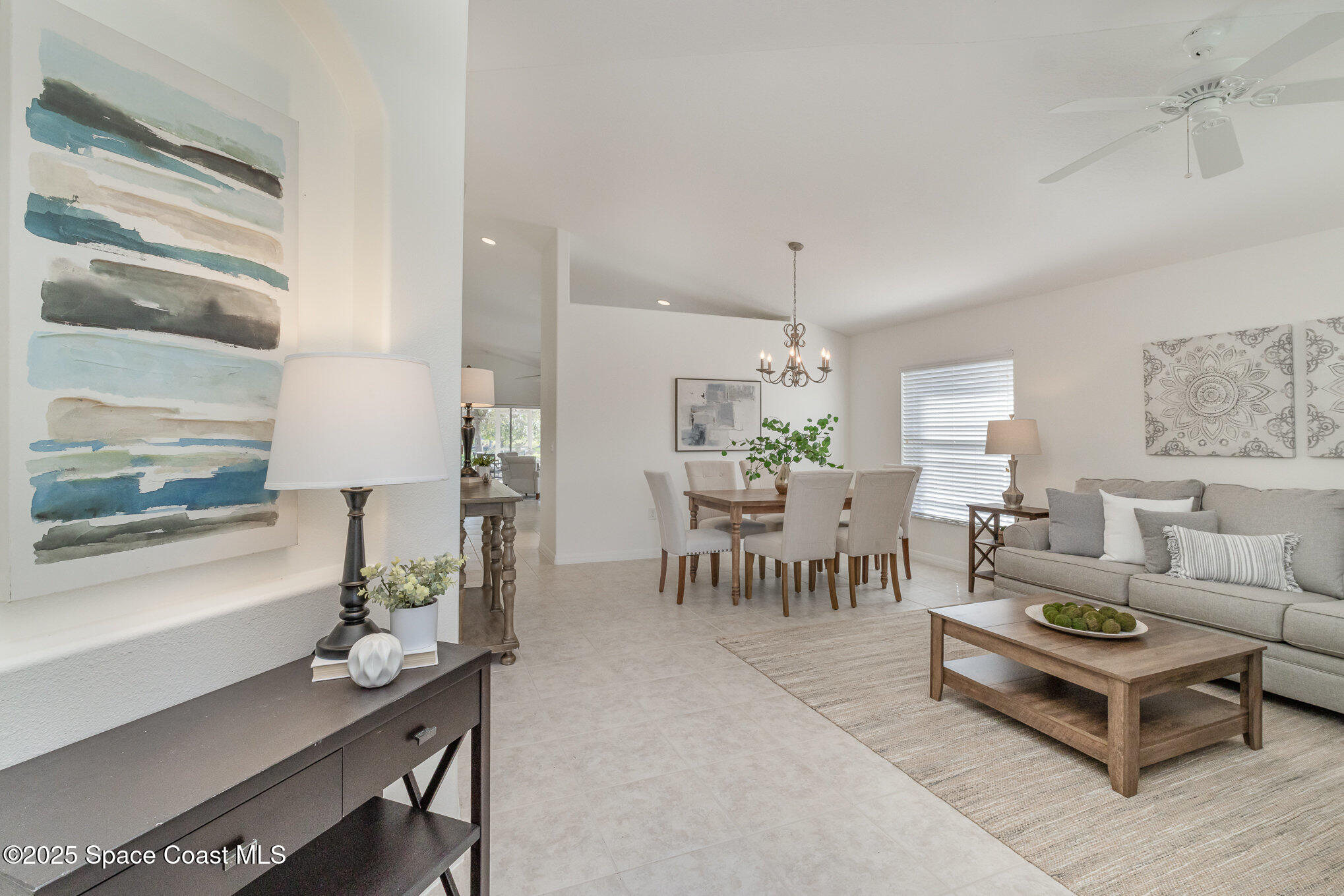 3053 Galindo Circle Melbourne, FL 32940 - Photo 8 of 83 a living room with furniture a table and a painting on the wall