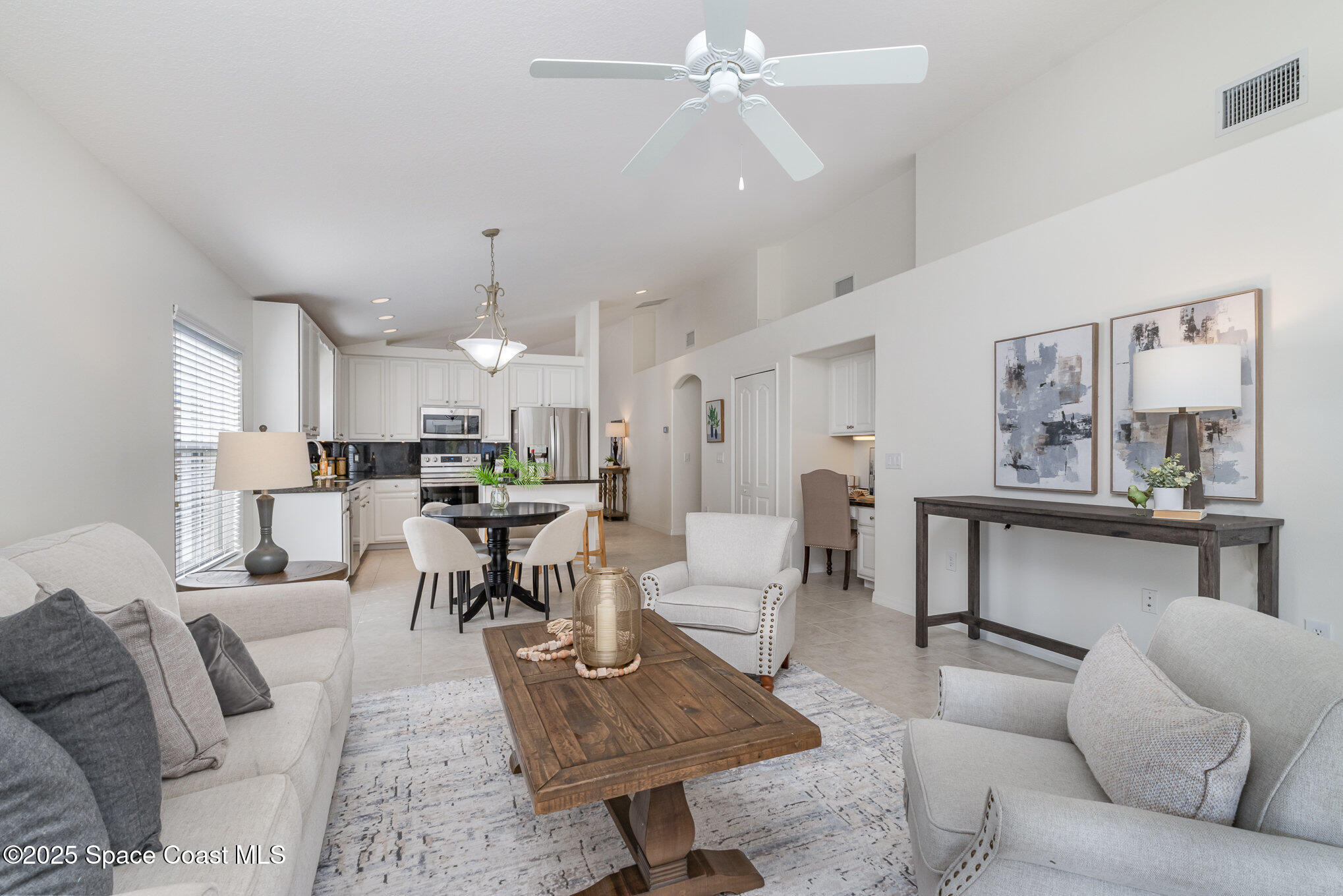 3053 Galindo Circle Melbourne, FL 32940 - Photo 10 of 83 a living room with furniture kitchen view and a chandelier