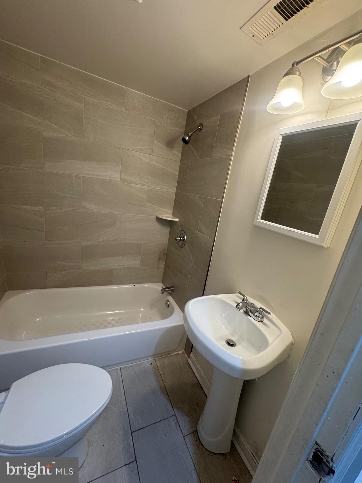 1108 North Bond Street, Unit 1 Baltimore, MD 21213 - Photo 16 of 20 a bathroom with a sink toilet and shower