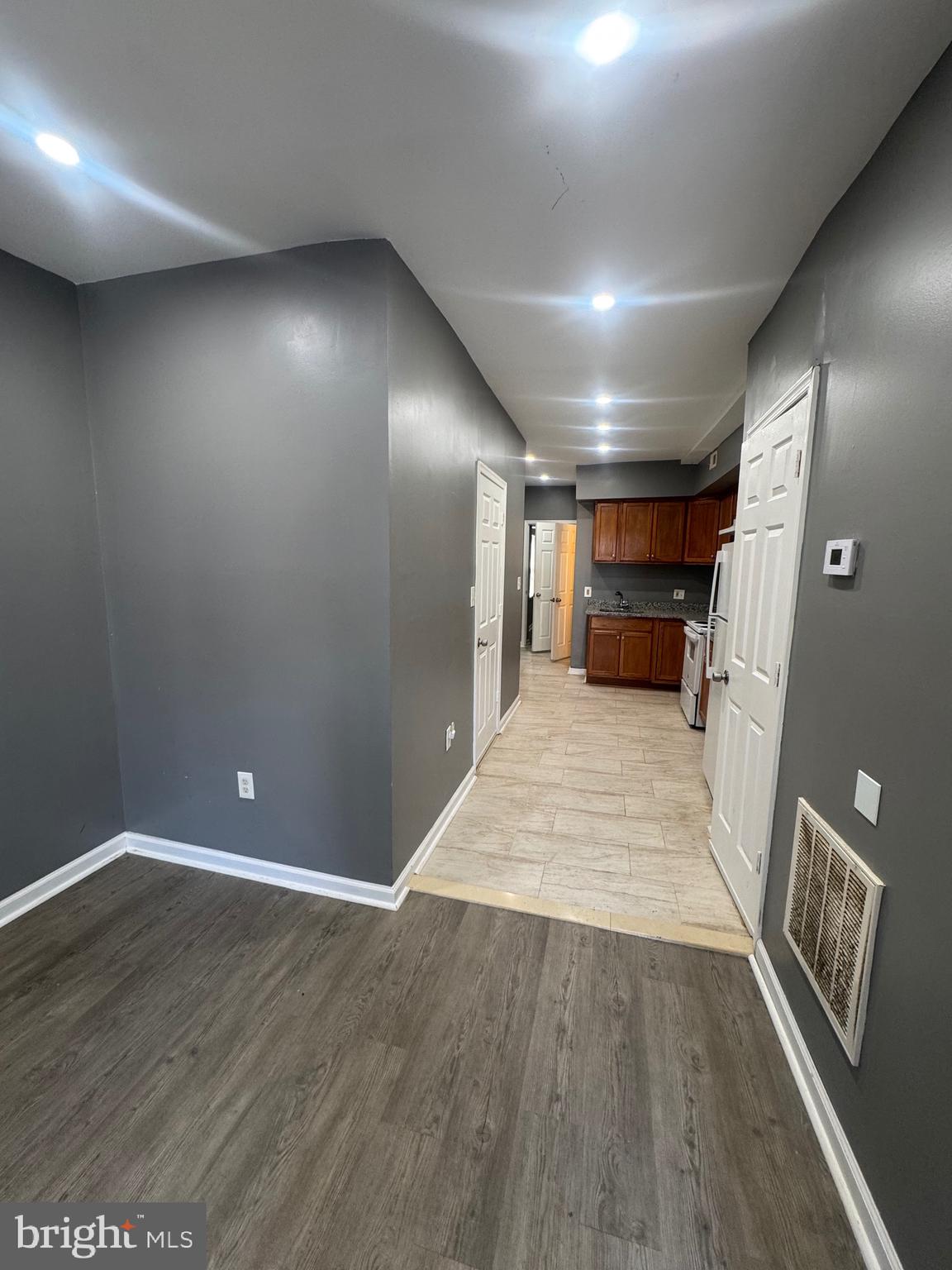 1108 North Bond Street, Unit 1 Baltimore, MD 21213 - Photo 9 of 20 an empty room with wooden floor and windows