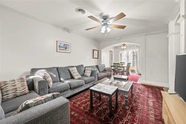 a living room with furniture and a chandelier