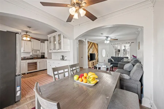a living room with stainless steel appliances kitchen island granite countertop furniture and a view of kitchen