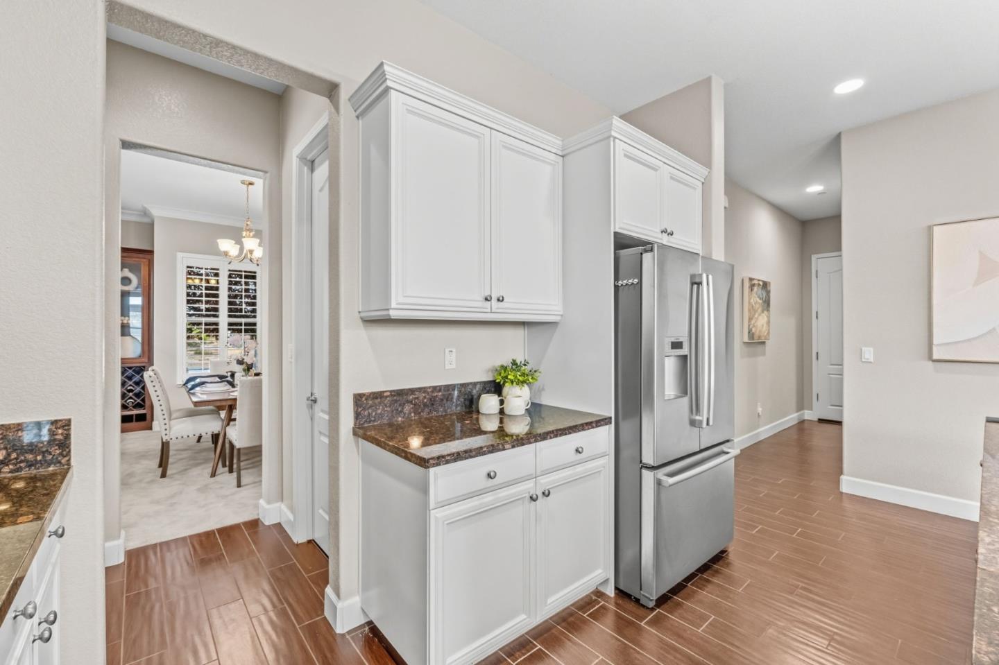 3716 Chiavari Way Manteca, CA 95337 - Photo 15 of 71 a kitchen with white cabinets and refrigerator