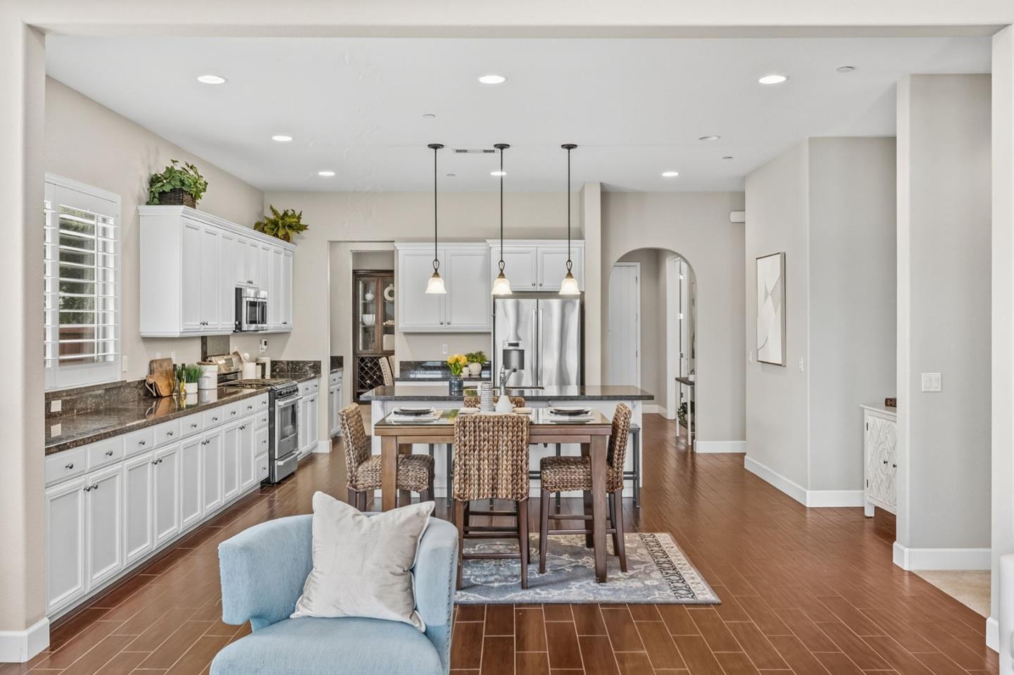 3716 Chiavari Way Manteca, CA 95337 - Photo 16 of 71 a large kitchen with cabinets wooden floor and stainless steel appliances