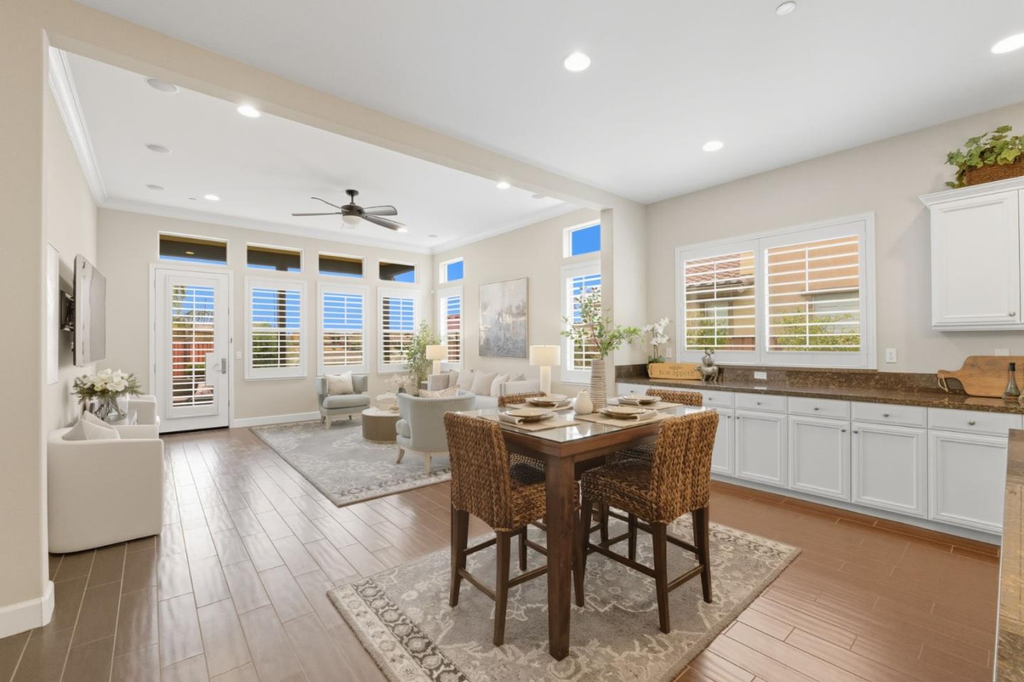 3716 Chiavari Way Manteca, CA 95337 - Photo 20 of 71 a large dining hall with stainless steel appliances granite countertop a stove a sink a dining table and chairs with wooden floor