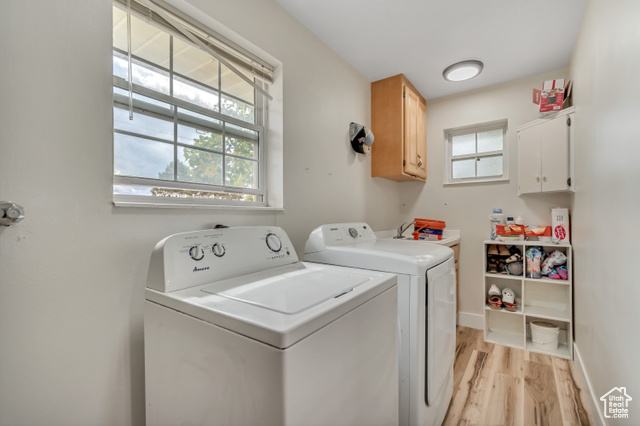 1225 North 1380th Street West Mapleton, UT 84664 - Photo 17 of 18 Laundry area with light wood-style floors, washer and dryer, and cabinet space