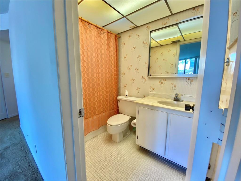 7650 West McNab Road, Unit 108 Tamarac, FL 33321 - Photo 8 of 18 a bathroom with a granite countertop sink toilet and shower