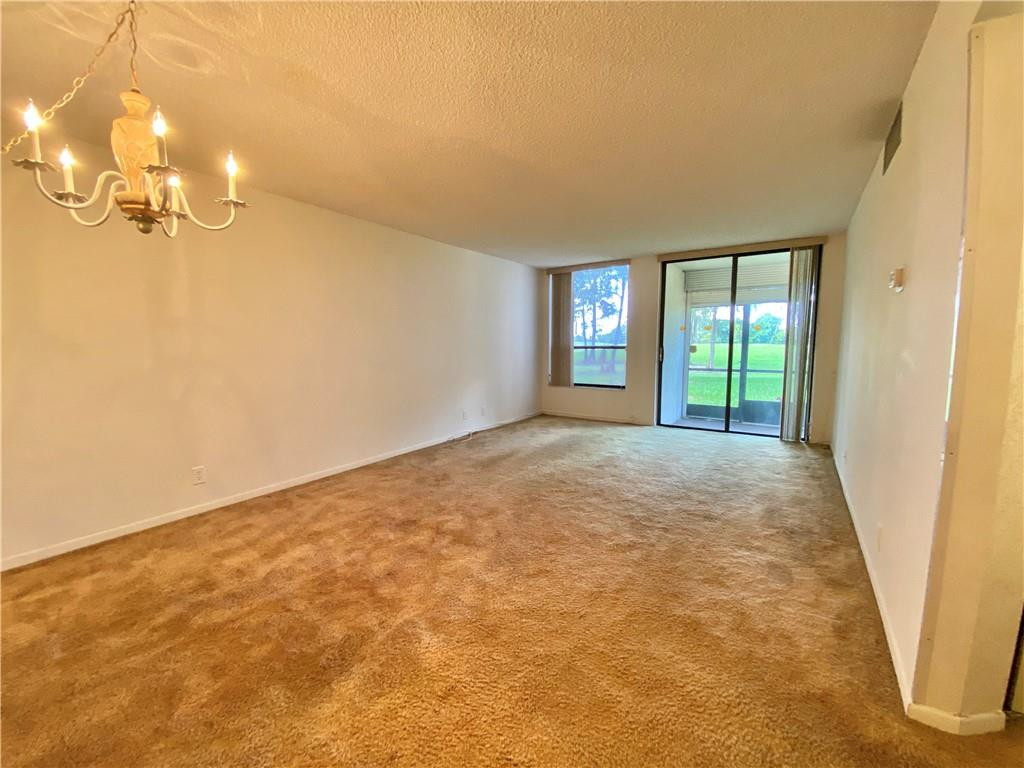 7650 West McNab Road, Unit 108 Tamarac, FL 33321 - Photo 9 of 18 an empty room with windows