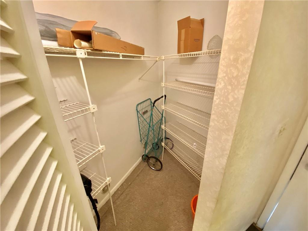 7650 West McNab Road, Unit 108 Tamarac, FL 33321 - Photo 10 of 18 a view of walk in closet with empty racks