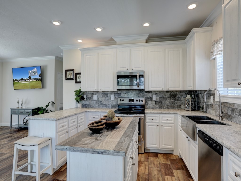 1011 Barefoot Circle Barefoot Bay, FL 32976 - Photo 11 of 31 a kitchen with a sink stove and cabinets