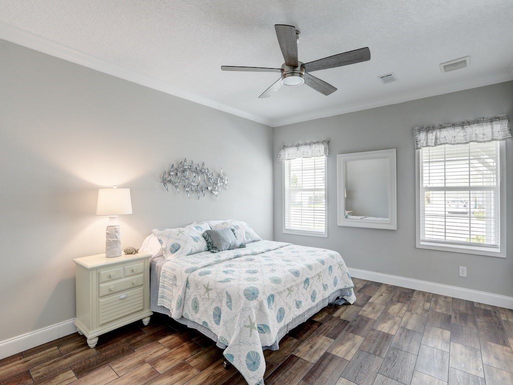 1011 Barefoot Circle Barefoot Bay, FL 32976 - Photo 12 of 31 a bedroom with a large bed and a window