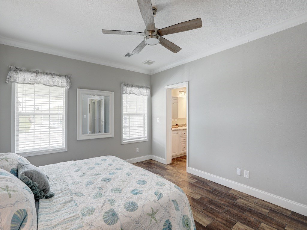 1011 Barefoot Circle Barefoot Bay, FL 32976 - Photo 13 of 31 a bedroom with a bed and a window