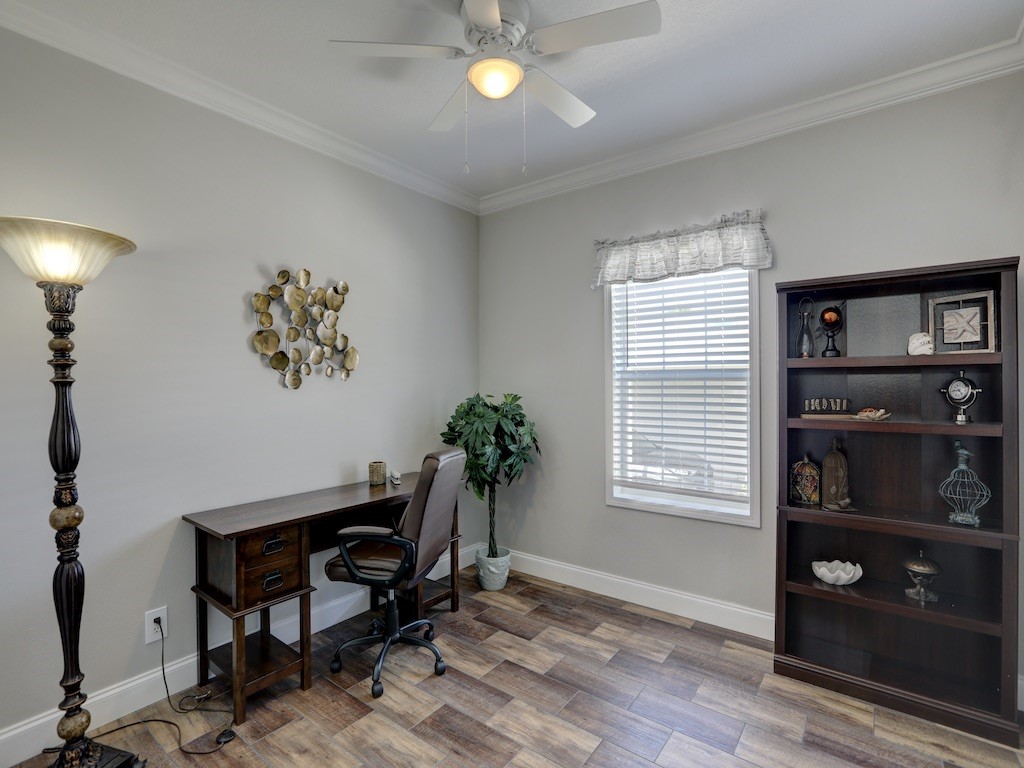 1011 Barefoot Circle Barefoot Bay, FL 32976 - Photo 16 of 31 a workspace with a bookshelf