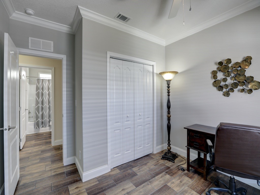 1011 Barefoot Circle Barefoot Bay, FL 32976 - Photo 17 of 31 a view of a workspace with wooden floor and bathroom view